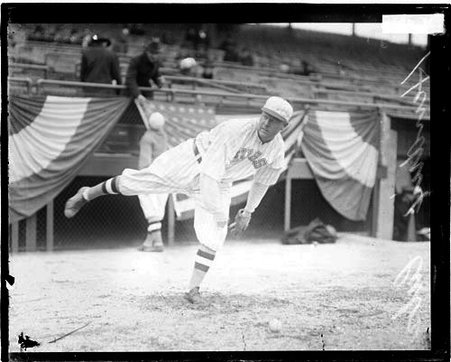 Baseball player, Hendrix, Cubs, following through after throwing a baseball on the field at Weeghman Field - Chicago Daily News, Inc.
