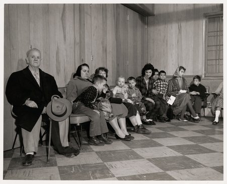 Men and women in a waiting room of the Erie Neighborhood House - Allen, Gordon, Schroeppel & Redlich, Inc.