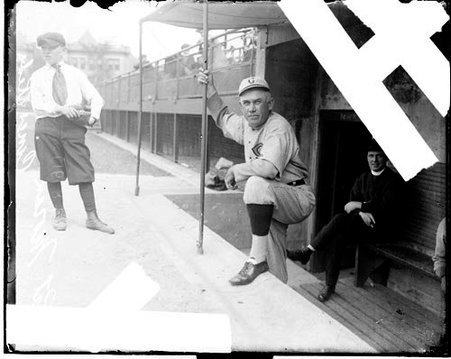 Baseball player Pat Moran, Cincinnati Reds, standing in a dugout at Weeghman Field - Chicago Daily News, Inc.