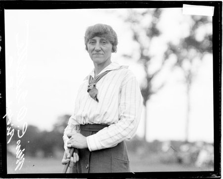 Golfer Mrs. C. O. Gillette holding a golf club on the grounds of an unidentified golf club - Chicago Daily News, Inc.