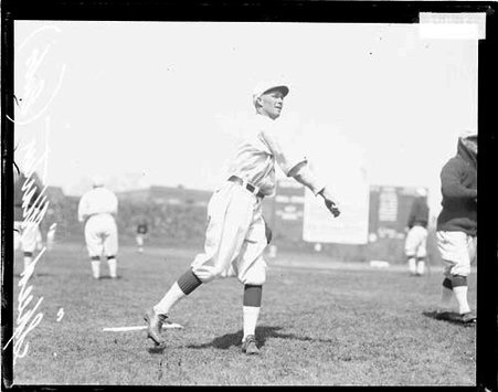 Baseball player Martin, Cubs, following through after throwing a baseball on the field at Weeghman Field - Chicago Daily News, Inc.