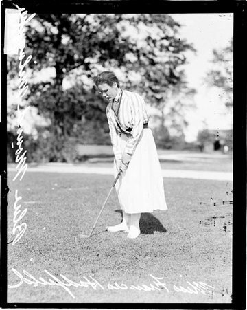 Golfer Miss Frances Hadfield gripping a golf club, standing on the grounds of an unidentified golf club - Chicago Daily News, Inc.