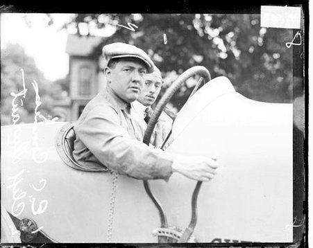 Motorist Cliff Durant sitting in the driver's seat of an automobile parked outdoors - Chicago Daily News, Inc.