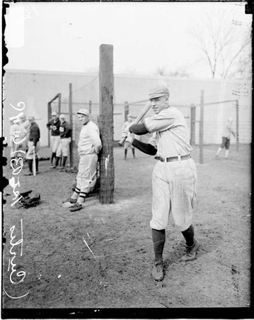 University of Chicago first baseman Curtis following through after swinging a baseball bat on the field at Stagg Field - Chicago Daily News, Inc.