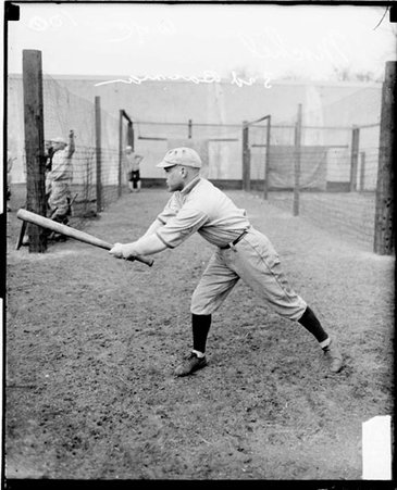 University of Chicago second baseman Mochel, standing in profile in a batting stance in front of a fenced area at Stagg Field - Chicago Daily News, Inc.