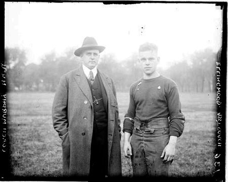 Northwestern University football coach Fred Murphy and assistant coach L. Ellingwood standing on a grass field - Chicago Daily News, Inc.