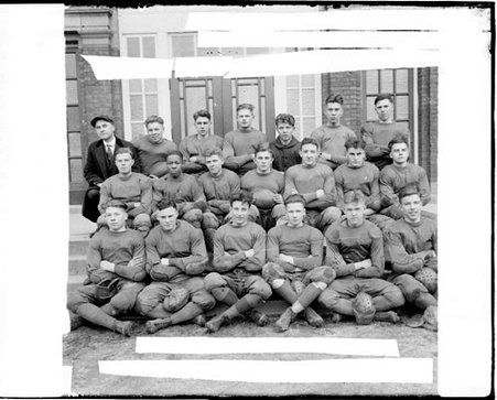 Members of the Englewood High School football team sitting in three rows in front of a building - Chicago Daily News, Inc.