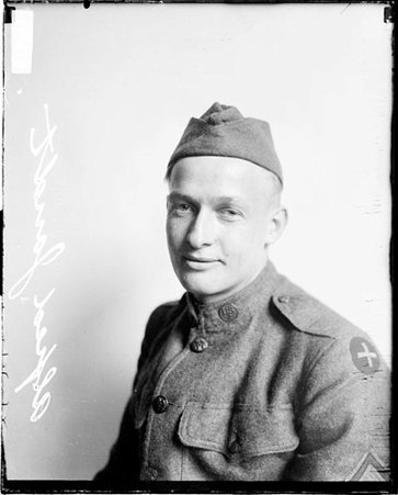Alfred Jandt wearing a military uniform, sitting in front of a light-colored backdrop in a room - Chicago Daily News, Inc.