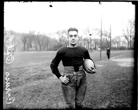 Oak Park football player Caruso holding a football - Chicago Daily News, Inc.