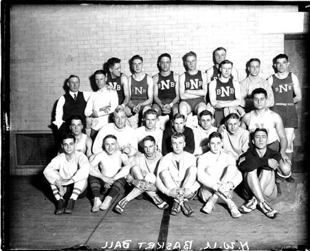 Twenty-three members of the Northwestern University basketball team gathered in front of a brick wall - Chicago Daily News, Inc.
