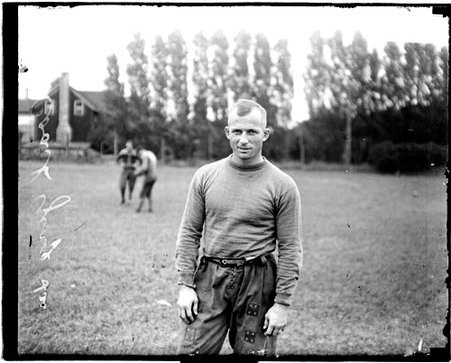 Northwestern University football coach George Sai standing on an athletic field - Chicago Daily News, Inc.