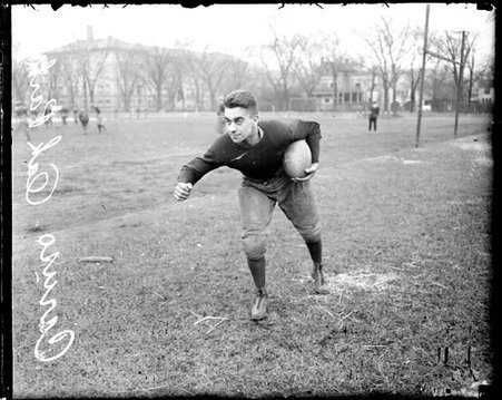 Oak Park football player Caruso holding a football under his left arm - Chicago Daily News, Inc.