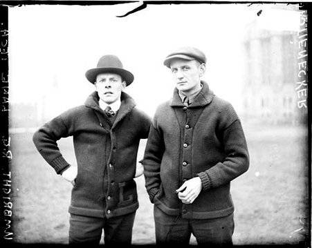 Umbright, Lane Technical High School, and Stienecker wearing street clothes, standing on a grass area in front of buildings - Chicago Daily News, Inc.