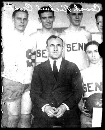 Senn High School coach Richard Crooke sitting in a room - Chicago Daily News, Inc.