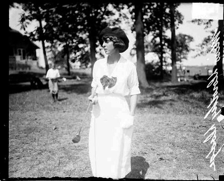 Golfer, Miss Dorothy Dodge holding a golf club, on the grounds of an unidentified golf club - Chicago Daily News, Inc.