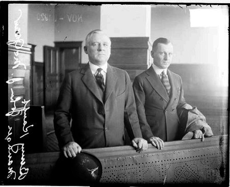 Baseball player, Kauff, New York Giants, and Giants manager John J. McGraw standing behind a low wall in a courtroom - Chicago Daily News, Inc.