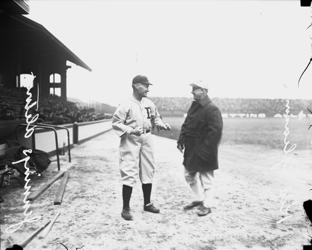 Baseball managers Kid Gleason, White Sox and Hugh Jennings, Tigers, standing on the field at Comiskey Park - Chicago Daily News, Inc.