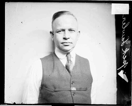 Jack Lawler wearing street clothes, standing in front of a light-colored backdrop in a room - Chicago Daily News, Inc.