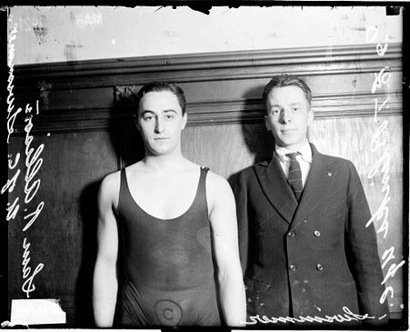 University of Chicago swimmers Allison and Blinks standing in front of a wood-paneled wall in a room - Chicago Daily News, Inc.