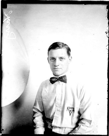 Bowler, Harry Kaads sitting in front of a light-colored backdrop in a room - Chicago Daily News, Inc.