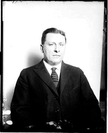 Bowler, Joe Shaw sitting in front of a light-colored backdrop in a room - Chicago Daily News, Inc.