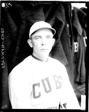 Baseball player Freeman, Cubs, sitting in a dugout at Weeghman Field - Chicago Daily News, Inc.