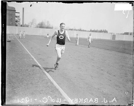 University of Chicago track and field athlete A. J. Barkey running on the athletic track at Stagg Field - Chicago Daily News, Inc.