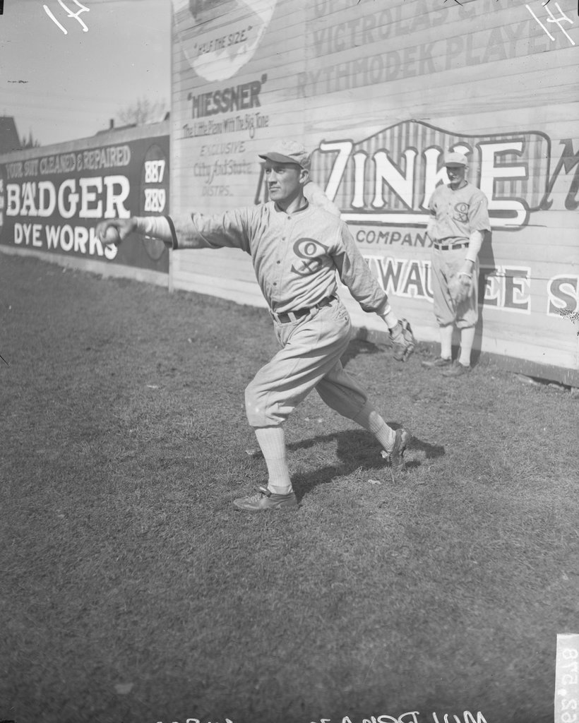 Baseball player, Dominic Mulrenan following through after throwing a baseball in the outfield at Comiskey Park - Chicago Daily News, Inc.
