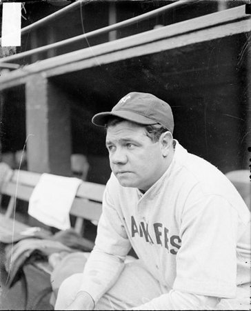 Baseball player, Babe Ruth, New York Yankees, sitting in a dugout at Comiskey Park - Chicago Daily News, Inc.