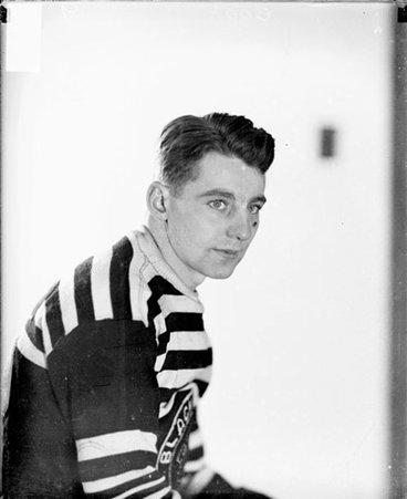 Chicago Black Hawks ice hockey player Thomas Cook sitting in front of a light-colored backdrop, dark exposure - Chicago Daily News, Inc.