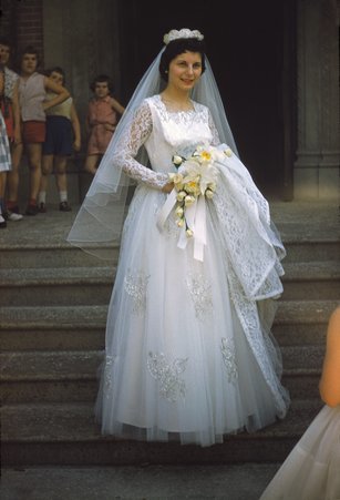 Bride on church steps with children behind - Unknown