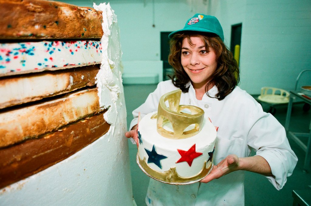 Woman posing with presidential-themed cheesecake - Chicago Sun-Times