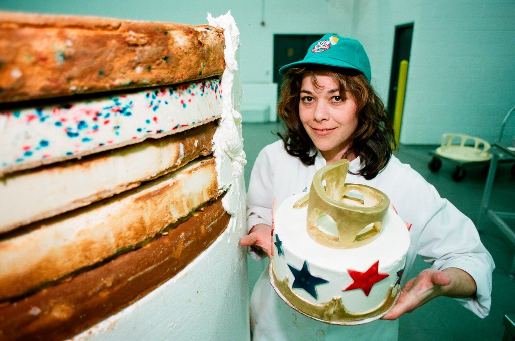 Woman posing with presidential-themed cheesecake - Chicago Sun-Times