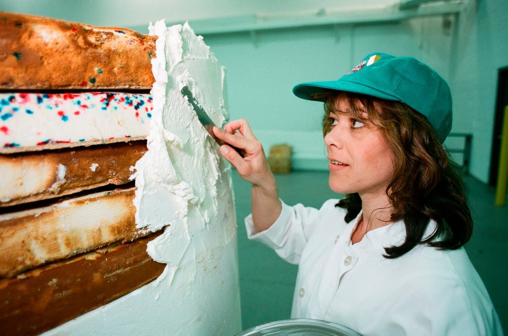 Woman posing with presidential-themed cheesecake - Chicago Sun-Times