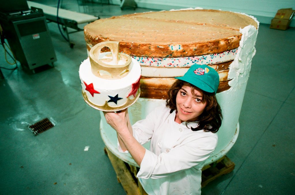 Woman posing with presidential-themed cheesecake - Chicago Sun-Times