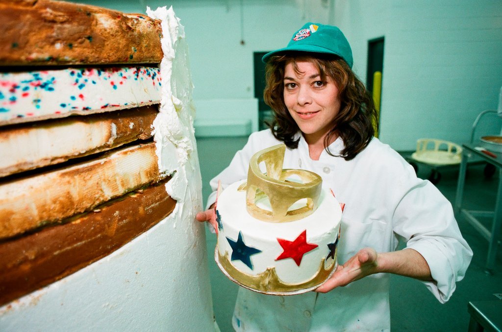 Woman posing with presidential-themed cheesecake - Chicago Sun-Times