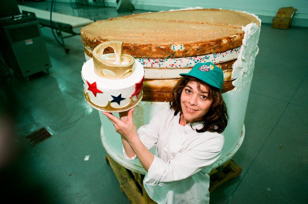 Woman posing with presidential-themed cheesecake - Chicago Sun-Times