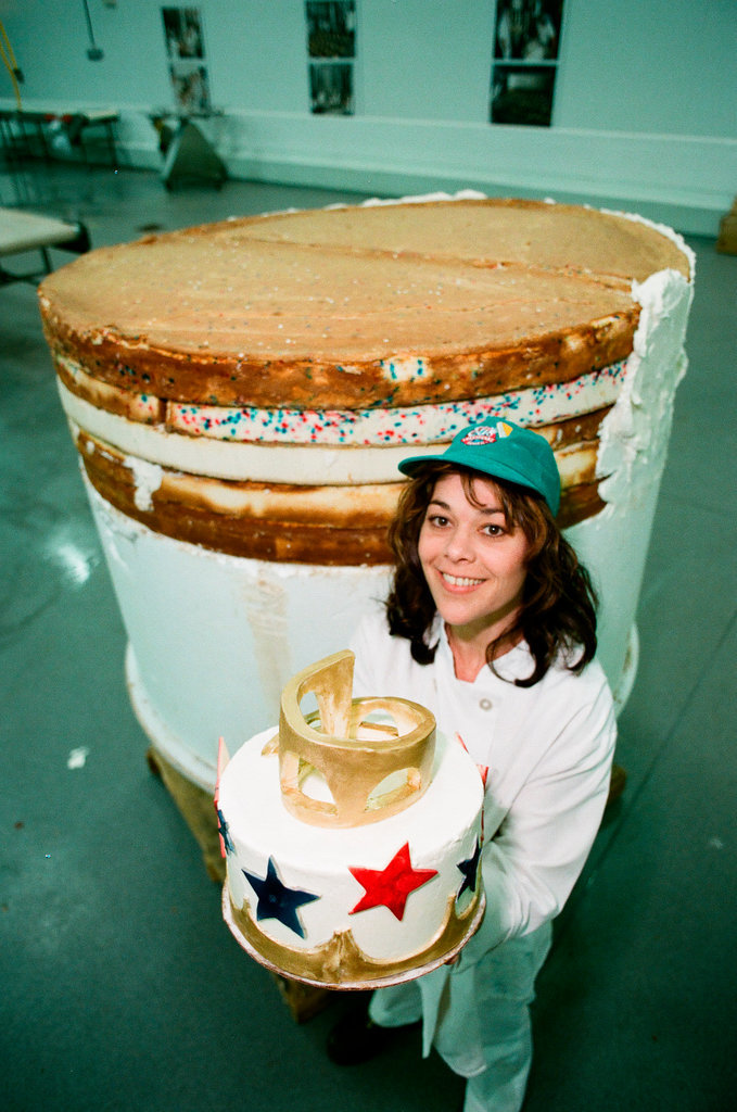 Woman posing with presidential-themed cheesecake - Chicago Sun-Times