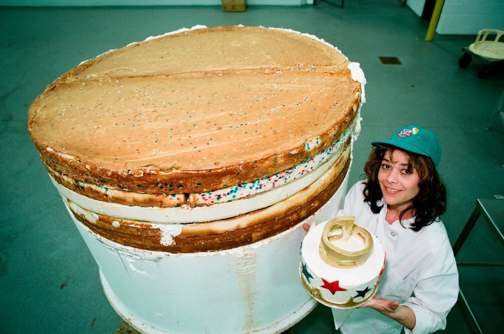 Woman posing with presidential-themed cheesecake - Chicago Sun-Times