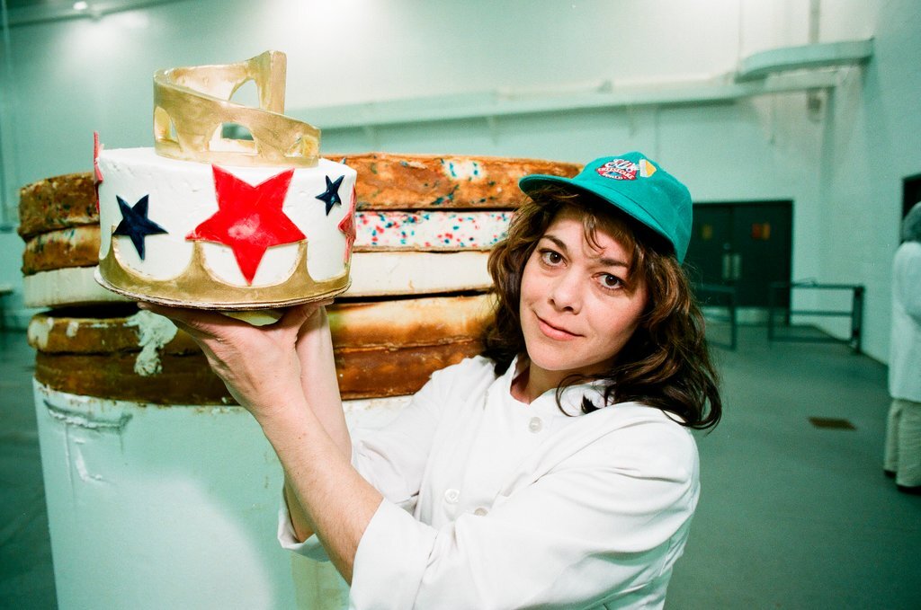 Woman posing with presidential-themed cheesecake - Chicago Sun-Times