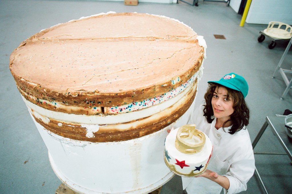 Woman posing with presidential-themed cheesecake - Chicago Sun-Times