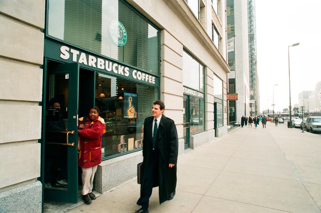 Coffee drinkers talk outside of Starbucks - Chicago Sun-Times