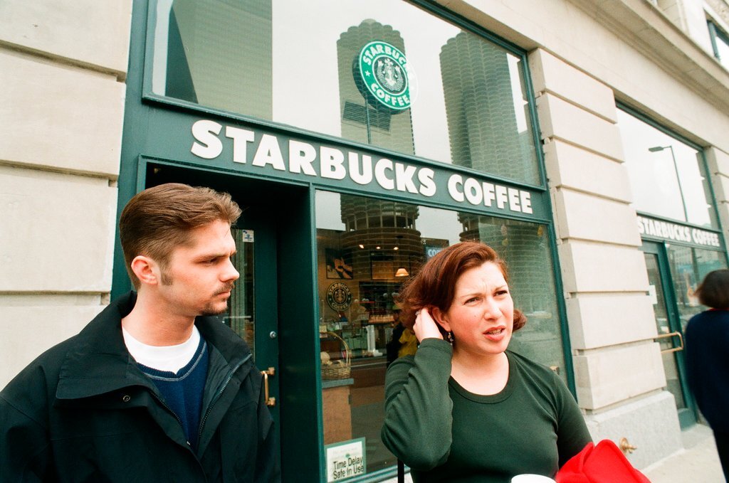 Coffee drinkers talk outside of Starbucks - Chicago Sun-Times