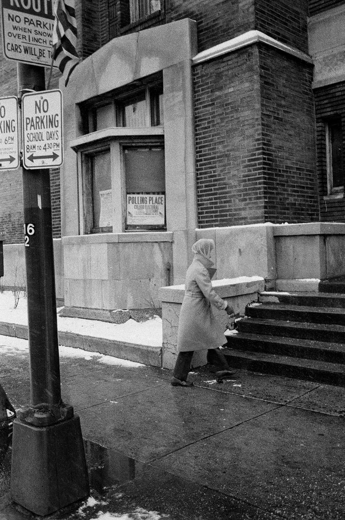 Women walking past a polling place - Chicago Sun-Times