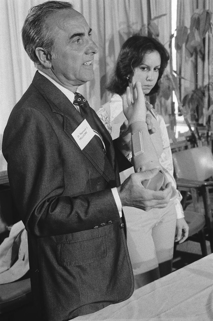 Dr. Raymond Pellicore demonstrating prosthetic arms - Chicago Sun-Times