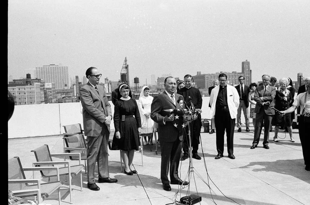 Flag raising ceremony on the roof of Mercy Hospital - Chicago Sun-Times