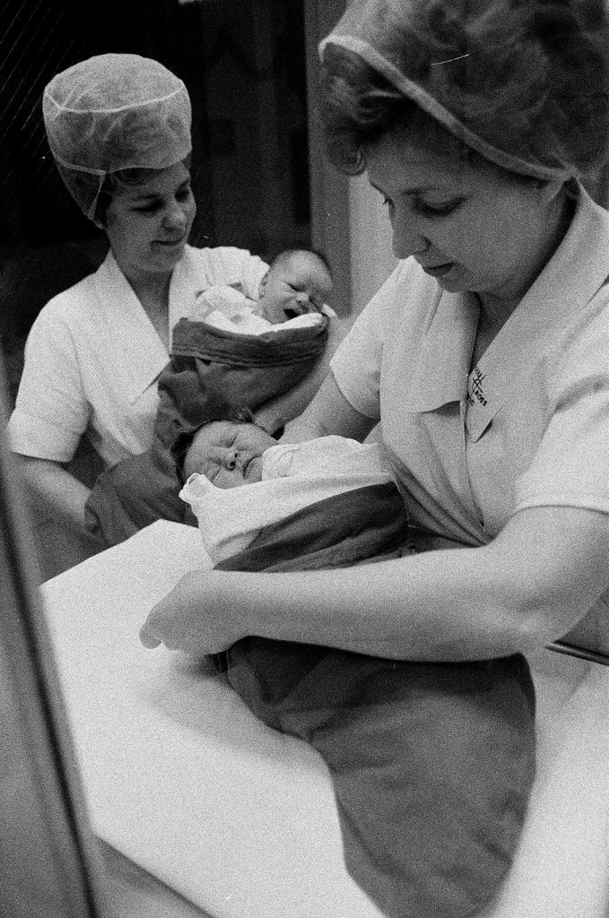 Nurses putting babies in Christmas stockings - Chicago Sun-Times