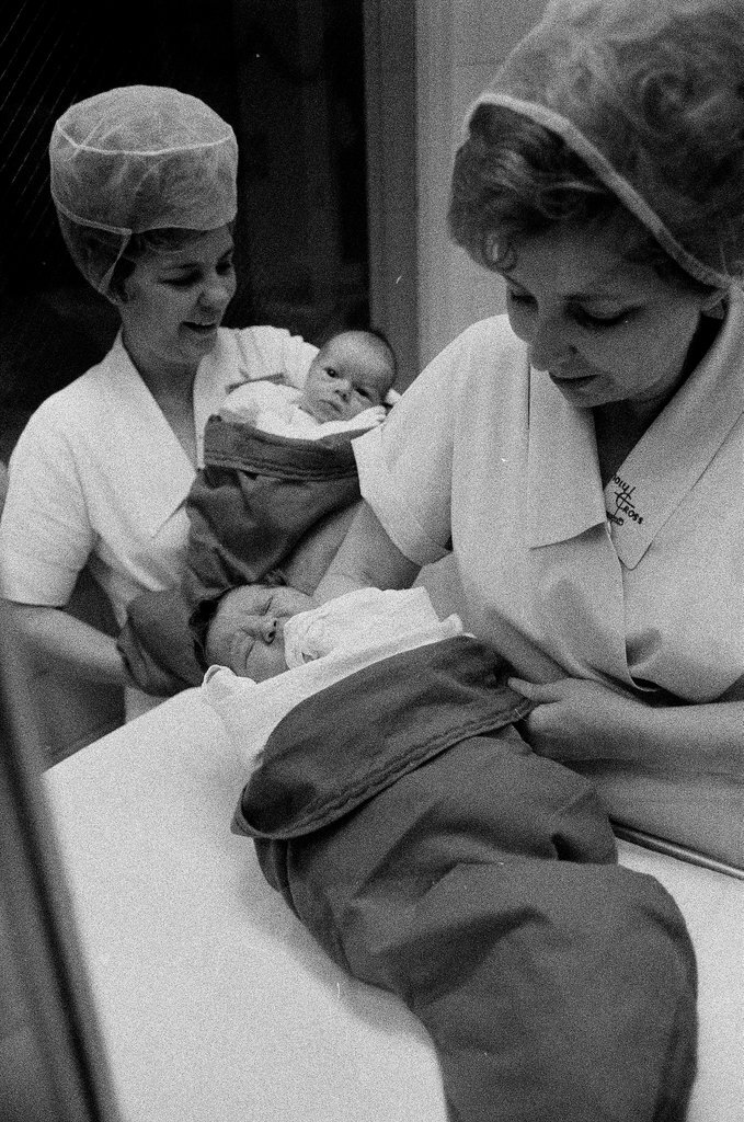 Nurses putting babies in Christmas stockings - Chicago Sun-Times