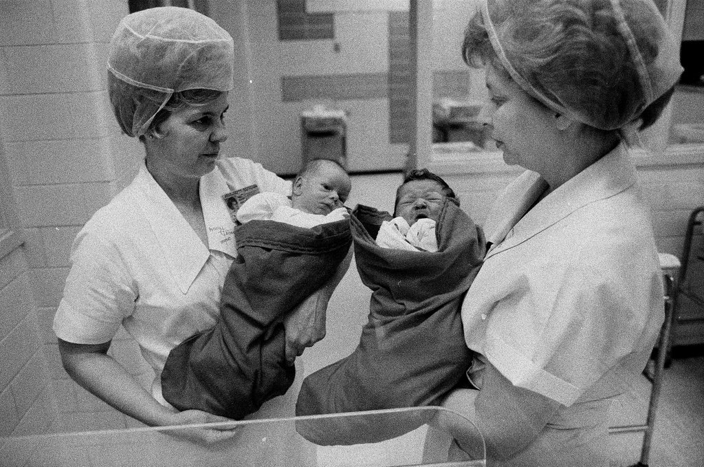 Nurses putting babies in Christmas stockings - Chicago Sun-Times