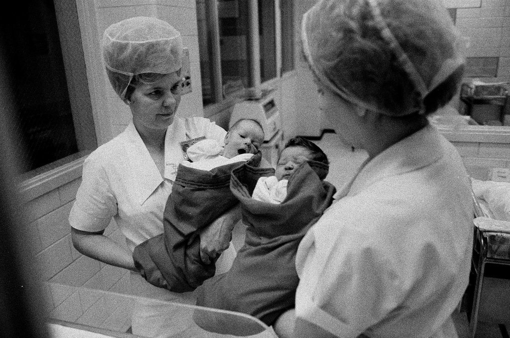 Nurses putting babies in Christmas stockings - Chicago Sun-Times